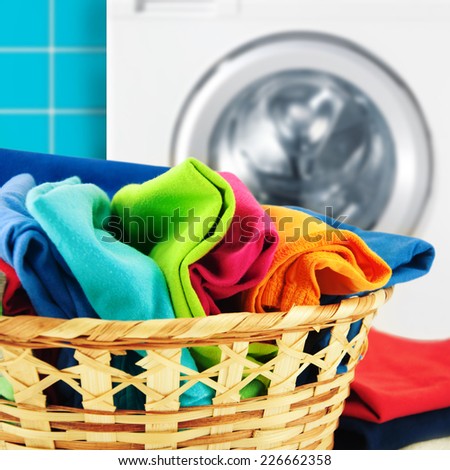 Pile of colorful clean clothes with washing machine.