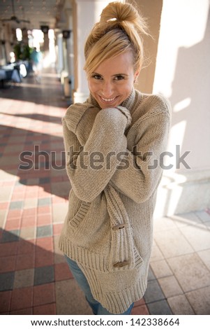 blonde hair model in an over sized sweater