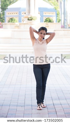 Outside shoot with model wearing peach colored tank top