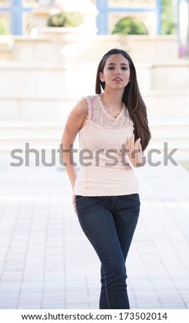 Outside shoot with model wearing peach colored tank top