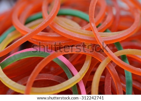 closeup a pile of color rubber bands in soft focus in background