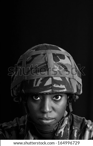 Black female soldier against a black background.