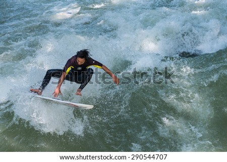 MUNICH - GERMANY, June 2. 2013. Surfer training on the Eisbach in the English Garden in Munich