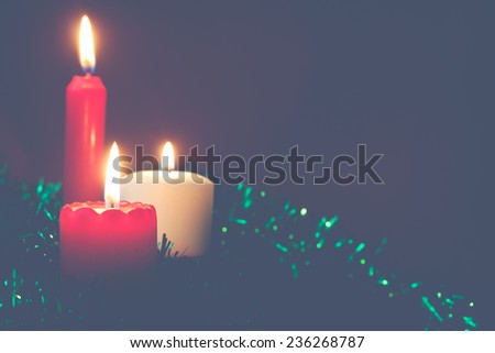 three candles on a green background