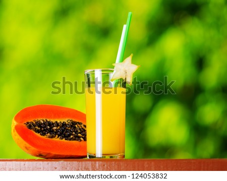 Glass of papaya juice in a garden.