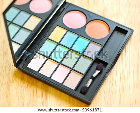 eyeshadow palette on wood background