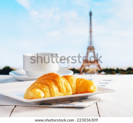 Cup of coffee and croissant in Paris. French cafe.
