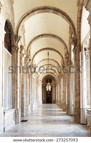 The passage with arches in the Royal Palace of Madrid in Spain. Madrid is a popular tourist destination of Europe.