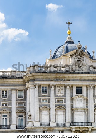 North side of facade of the Royal Palace of Madrid on the blue sky background in Spain. Madrid is a popular tourist destination of Europe.