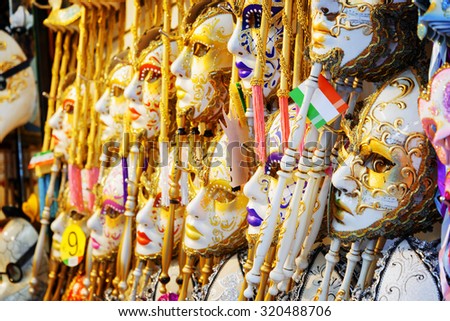 VENICE, ITALY - AUGUST 24, 2014: Side view of authentic and original Venetian full-face masks for Carnival. Ornate colorful masks in souvenir shop on the Rialto Bridge (Ponte di Rialto).