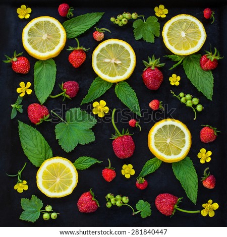 Summer fruit pattern of the fresh strawberry, lemon, mint leaves, green currants and yellow flowers on the black background