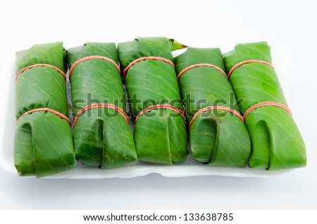pickled fish wrapped in banana leaves.