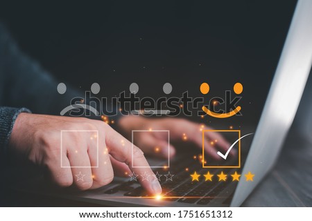 Customer service satisfaction survey concept.Business people or customers show satisfaction through the application on the tablet screen. By giving the most satisfaction rating and 5 stars.