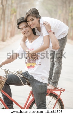 A short of loving couple riding on bike in the nature