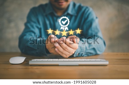 Hand shows the sign of the top service Quality assurance 5 star, Guarantee, Standards, ISO certification and standardization concept.