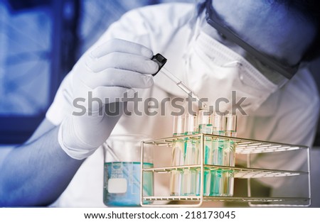 Test tubes closeup,medical glassware Man. wears protective goggles
