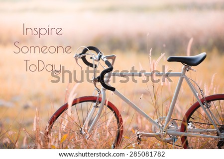 Sport Vintage Bicycle with Summer grass field ; life quote. Inspirational quote. Motivational background