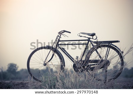 beautiful landscape image with Bicycle at sunset;vintage color tone style