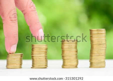 Money Gold coin Steps with green bokeh background ,Business Finance and Money concept
