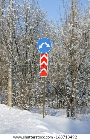Road signs on a snowy road
