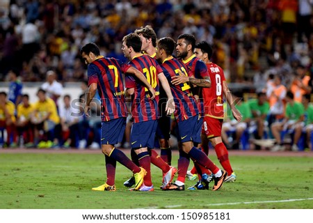 BANGKOK, THAILAND - AUGUST 7: Unidentified player of Barcelona is congratulated by team mates during the international friendly match Thailand XI and Barcelona at Rajamangala Stadium on Aug7,2013 in,Thailand.