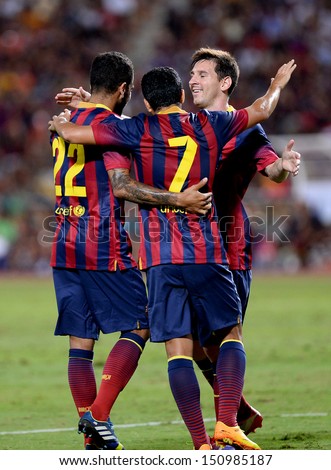 BANGKOK, THAILAND - AUGUST 7: Lionel Messi of FC Barcelona is congratulated by team mates during the international friendly match Thailand XI and FC Barcelona at Rajamangala Stadium on August7,2013 in,Thailand.