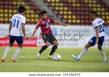 PATHUMTHANI THAILAND-MAY 05:Tana Chanabut(Crimson)of Police Utd.in action during a Thai Premier League match between Police Utd.and Songkhla Utd.at Thammasat Stadium on May 05,2014,Thailand