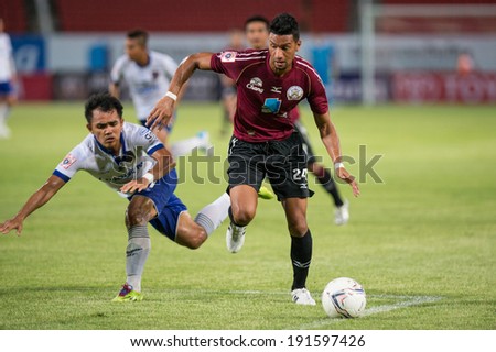 PATHUMTHANI THAILAND-MAY 05:Michael Murcy(Crimson)of Police Utd.compete for the ball during  Thai Premier League match between Police Utd.and Songkhla Utd.at Thammasat Stadium on May 05,2014,Thailand