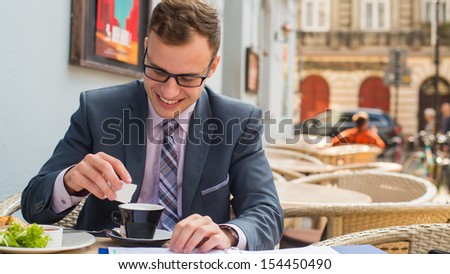 A close-up portrait of a businessman having breakfast.