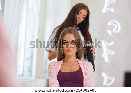 Hairdresser doing haircut for women in hairdressing salon. Concept of fashion and beauty. Positive emotion