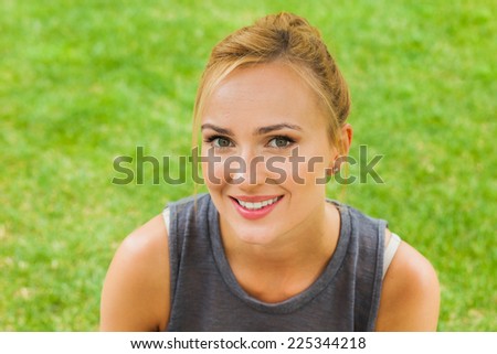 Summer girl portrait. Caucasian blonde woman smiling happy on sunny summer or spring day outside in park.