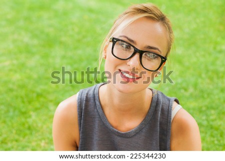 Summer girl portrait. Caucasian blonde woman smiling happy on sunny summer or spring day outside in park.