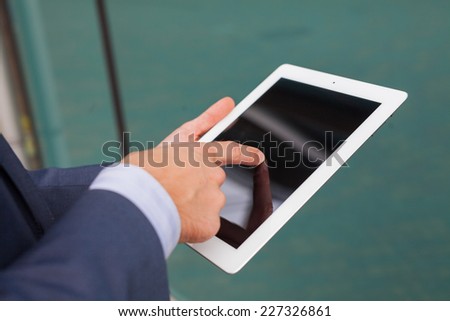 Close up of businessman hands with tablet pc. Copy space.