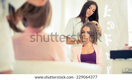 Hairdresser doing haircut for women in hairdressing salon. Concept of fashion and beauty. Positive emotion.
