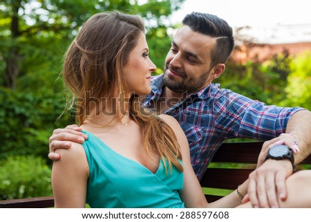 Couple sitting on the bench, they are in love