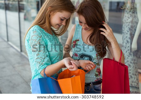 Young girls unpacking their shopping bags. Season of sales