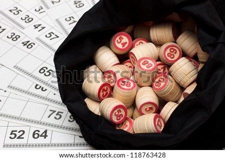 Lotto. Wooden kegs in a sack and game cards.