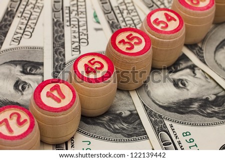 Wooden kegs on a pile of money.