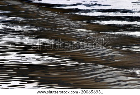 Highly embossed, mottled night waves, under the bright moonlight. Cold-brown tinted negative image. Waves: relief on the water surface, a series of images