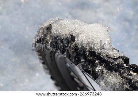 Studge ice on the narrow bike wheel, No.2. Melted snow on the narrow tread-wheel