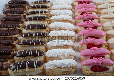Ekler Pasta Chocolate Donut in plate. A lot of french dessert of profiteroles(eclair) choux pastry. Turkish delicious eclairs pasta. Stok fotoğraf © 