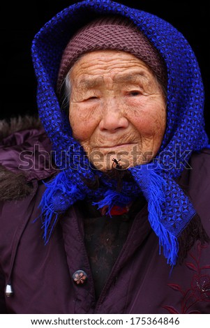 Portrait of a 95 years old woman, born in 1919, the last generation that bind the feet of woman