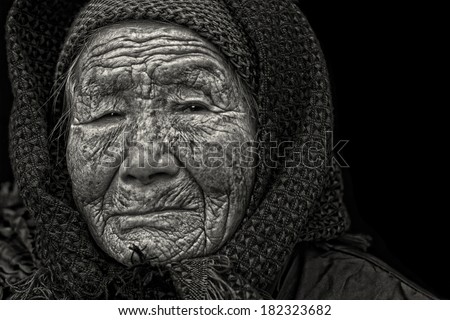 Black and white portrait of a 95 years old woman, born in 1919, with depression, the last generation that bind the feet of woman