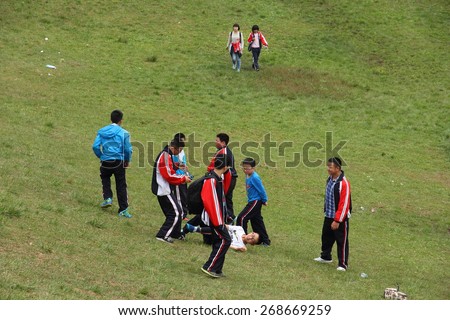 CHENGDU, CHINA - MARCH 31: Unidentified kids playing on a grass slope in the park, March 31, 2015, Chengdu, China.
