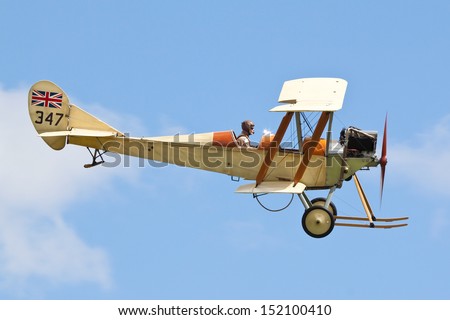 WOBURN ABBEY, BEDFORDSHIRE, UK - AUGUST 18: Royal Aircraft Factory BE.2c replica flying on August 18, 2013 at the De Havilland Moth Rally, Woburn Abbey, Bedfordshire, UK.