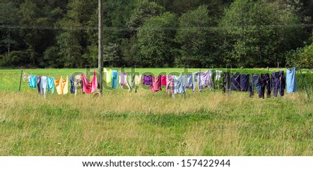 laundry clothes hanging oudoors and drying with rope and clothespins
