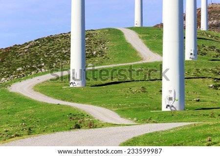 closeup of wind turbine towers with a path