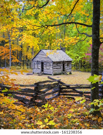 Old cabin framed by colorful fall foliage on Roaring Fork Road, Smoky Mountains National Park