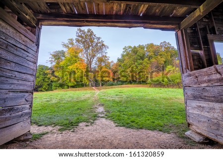 View of fall foliage from within a barn behind the famous John Oliver cabin in the Great Smoky Mountains National Park