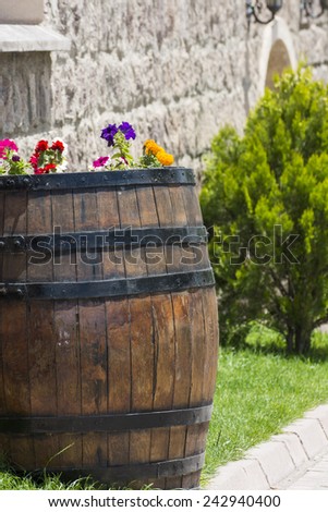 Summer flowers in a wooden barrel.